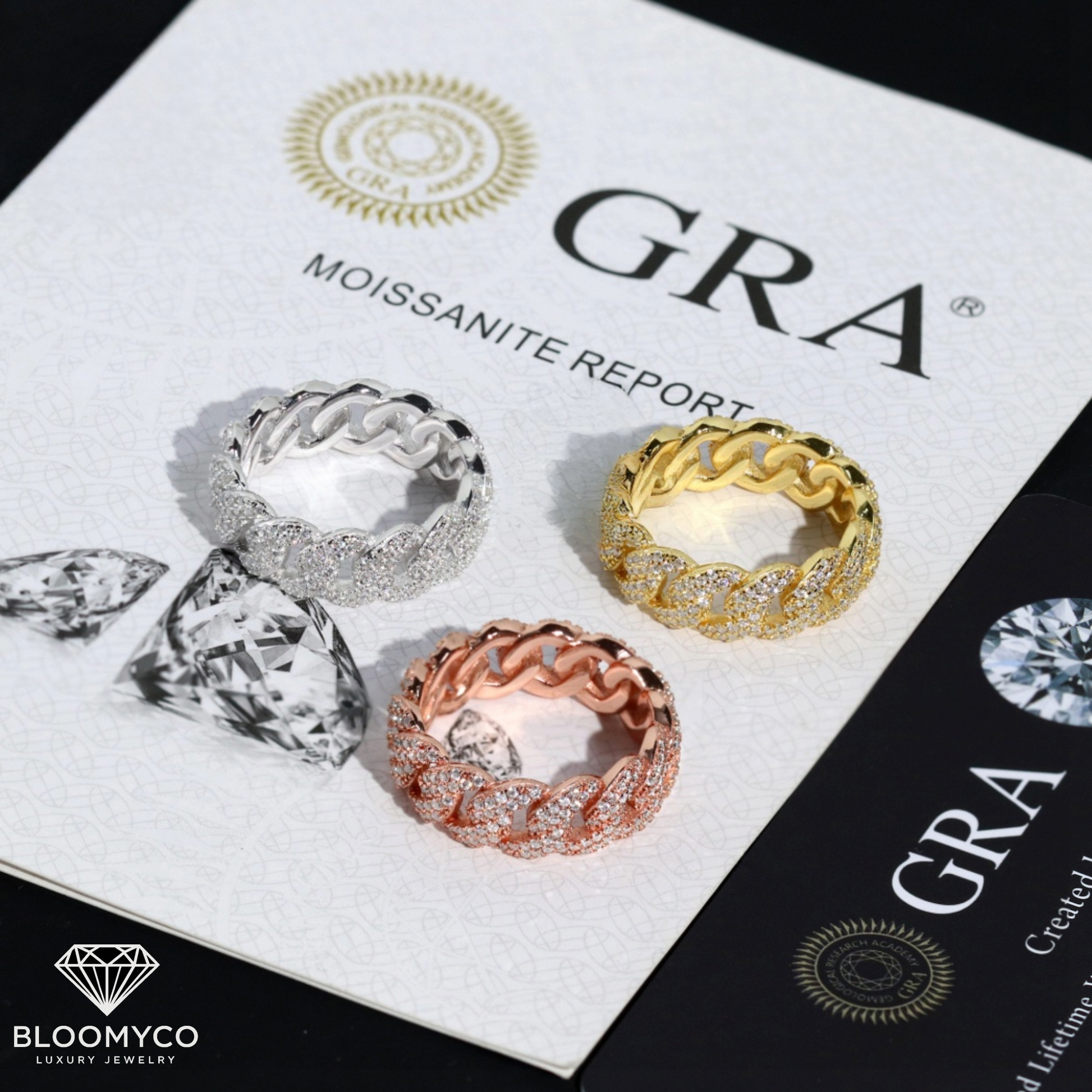 Three diamond rings on a display card with 'GRA' branding